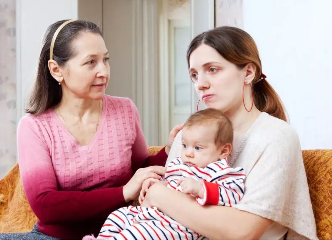 Mother Holding Baby With Elderly Woman